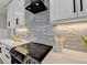 Modern kitchen featuring a glass tile backsplash, stainless steel appliances, and granite countertops at 1431 Torrington Dr, Auburn, GA 30011