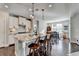 Bright kitchen featuring a granite island, white cabinets, and hardwood floors open to the breakfast nook at 1431 Torrington Dr, Auburn, GA 30011
