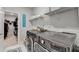 Functional laundry room featuring a modern washer and dryer, wire shelving, and stylish 'WASH' wall art at 1431 Torrington Dr, Auburn, GA 30011