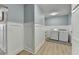 Well-lit laundry room with modern washer and dryer, and stylish wainscoting adding an elegant touch at 1431 Torrington Dr, Auburn, GA 30011