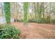 The backyard features trees and a storage shed, offering both natural beauty and practicality at 1770 Lynn Ln, Decatur, GA 30032