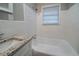 This bathroom features a granite countertop sink and new tiled tub/shower, providing a modern and clean space at 1770 Lynn Ln, Decatur, GA 30032