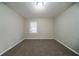 Cozy bedroom with neutral walls, carpet, a window, and modern lighting at 1770 Lynn Ln, Decatur, GA 30032