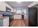 Modern kitchen featuring white cabinets, stainless steel appliances, and granite countertops at 1770 Lynn Ln, Decatur, GA 30032