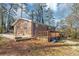 Cozy red brick single Gathering home with a side deck, a quaint yard, and a glimpse of the surrounding greenery at 2718 Amelia Ave, Decatur, GA 30032