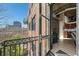 Balcony view features an iron railing with outdoor seating and a glimpse of the city skyline at 3235 Roswell Ne Rd # 710, Atlanta, GA 30305