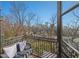 Cozy balcony with outdoor seating, offering a tranquil view of trees and city buildings in the distance at 3235 Roswell Ne Rd # 710, Atlanta, GA 30305