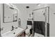 Modern bathroom featuring a sleek vanity, a contemporary sink, and a glass-enclosed shower with black and white tiling at 3235 Roswell Ne Rd # 710, Atlanta, GA 30305