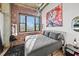 Bedroom boasts exposed brick, large windows, and modern decor at 3235 Roswell Ne Rd # 710, Atlanta, GA 30305