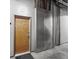 Hallway view showing a wooden door to the left with a metallic apparatus adjacent to the door at 3235 Roswell Ne Rd # 710, Atlanta, GA 30305
