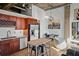 Kitchen area with stainless steel appliances, granite countertops, tile backsplash, and custom wooden cabinetry and a cozy dining space at 3235 Roswell Ne Rd # 710, Atlanta, GA 30305