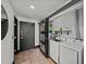 This laundry room features sliding glass doors with a modern washer and dryer at 3235 Roswell Ne Rd # 710, Atlanta, GA 30305