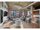 Open-concept living room with exposed brick, hardwood floors, and a modern kitchen in a renovated building at 3235 Roswell Ne Rd # 710, Atlanta, GA 30305