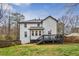Two-story house with deck and backyard with grassy area and wood fence at 4646 Breakwater Trl, Marietta, GA 30066