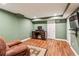 Finished basement space with a TV, desk, chair, rug, and laminate flooring at 4646 Breakwater Trl, Marietta, GA 30066