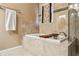 Luxurious soaking tub with tiled surround and decorative accents at 4646 Breakwater Trl, Marietta, GA 30066