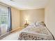 Cozy bedroom with a comfortable bed, floral bedding, a window with blinds, and soft lighting at 4646 Breakwater Trl, Marietta, GA 30066