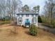 Charming two-story home features a vibrant blue door, bay windows, and a well-maintained front yard at 4646 Breakwater Trl, Marietta, GA 30066