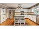 Well-appointed kitchen featuring white cabinets, stainless steel appliances, an island, and hardwood floors at 4646 Breakwater Trl, Marietta, GA 30066