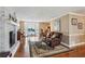 Bright living room with hardwood floors, large windows, brick fireplace, and comfortable seating area at 4646 Breakwater Trl, Marietta, GA 30066