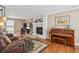 Cozy living room features a brick fireplace, hardwood floors, and comfortable leather seating at 4646 Breakwater Trl, Marietta, GA 30066