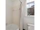 Cozy bathroom featuring a shower with white tile surround and a window at 9290 Waits Ferry Xing, Duluth, GA 30097