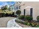 Landscaped front yard with stone pathway, flowerbeds, and manicured shrubs enhancing curb appeal at 9290 Waits Ferry Xing, Duluth, GA 30097