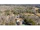 Aerial shot of property nestled among mature trees with golf course views and tennis court at 10 Colony Ridge Dr, Alpharetta, GA 30022