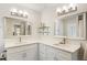 Bright bathroom featuring dual sinks with white cabinetry, quartz countertops and modern mirrors and lighting at 10 Colony Ridge Dr, Alpharetta, GA 30022