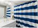 Bathroom with a vanity and a blue and white striped shower curtain with a view to the mirror at 10 Colony Ridge Dr, Alpharetta, GA 30022