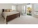 Serene bedroom with balcony access, plush carpet, and a view of nature at 10 Colony Ridge Dr, Alpharetta, GA 30022