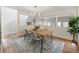 Bright dining room featuring hardwood floors, stylish chandelier, and a large window at 10 Colony Ridge Dr, Alpharetta, GA 30022