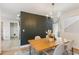 Cozy dining room featuring a black accent wall, hardwood floors, and a stylish chandelier at 10 Colony Ridge Dr, Alpharetta, GA 30022