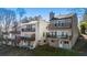 View of a multi-level townhome's with decks providing outdoor living space and treetop views from each residence at 10 Colony Ridge Dr, Alpharetta, GA 30022