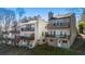 Multi-level townhome complex with balconies and neutral exteriors situated on a landscaped hillside at 10 Colony Ridge Dr, Alpharetta, GA 30022