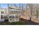 Two-story home featuring dual balconies, gray siding, and a wooded backyard at 10 Colony Ridge Dr, Alpharetta, GA 30022