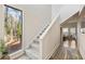 Bright hallway with a large window and wooden floors, leading to the upper level at 10 Colony Ridge Dr, Alpharetta, GA 30022