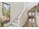 Bright entryway with a large window and staircase leading to the upper level with wood and carpet flooring at 10 Colony Ridge Dr, Alpharetta, GA 30022