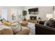 Bright living room with stone fireplace, hardwood floors, and comfortable seating arrangements at 10 Colony Ridge Dr, Alpharetta, GA 30022