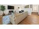 Inviting living room featuring a stone fireplace, hardwood floors, and large TV at 10 Colony Ridge Dr, Alpharetta, GA 30022