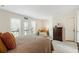 Comfortable main bedroom featuring a lounge area and access to a private balcony overlooking a natural tree view at 10 Colony Ridge Dr, Alpharetta, GA 30022
