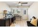 Home office with tiled floor, natural light, desk, monitors, storage and a door to the outside at 10 Colony Ridge Dr, Alpharetta, GA 30022