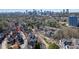 Aerial shot of homes with trees and landscaping, capturing city skyline in the distance on a sunny day at 1029 Fairway Ne Ests, Atlanta, GA 30319