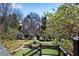 Landscaped backyard with a lush lawn and decorative stone steps leading to a terraced garden at 1029 Fairway Ne Ests, Atlanta, GA 30319