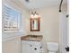 Bathroom featuring granite countertop sink, decorative framed mirror, and natural light from window at 1029 Fairway Ne Ests, Atlanta, GA 30319