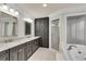 Bathroom with white tile flooring, a soaking tub, and a double sink vanity at 1029 Fairway Ne Ests, Atlanta, GA 30319