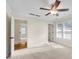 Sunlit bedroom featuring a ceiling fan, neutral carpet and paint, and two entryways at 1029 Fairway Ne Ests, Atlanta, GA 30319