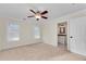 Bedroom with neutral carpet, ceiling fan, and an ensuite bathroom providing comfort and convenience at 1029 Fairway Ne Ests, Atlanta, GA 30319