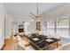 Open-concept dining area with a black marble table and white chairs at 1029 Fairway Ne Ests, Atlanta, GA 30319