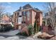 Brick home featuring a two-car garage, landscaped front yard, and traditional architectural details at 1029 Fairway Ne Ests, Atlanta, GA 30319